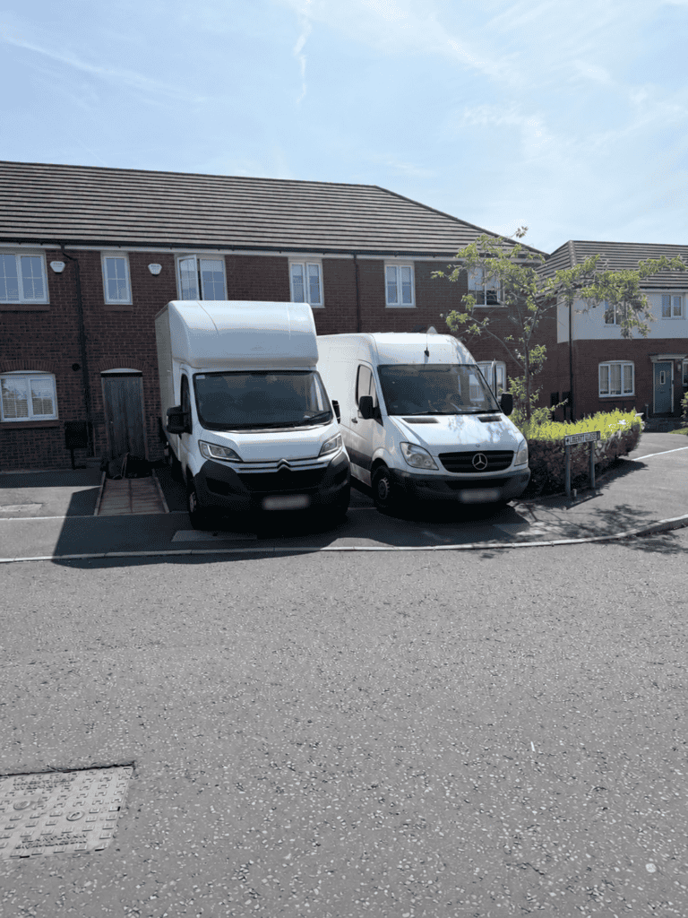 How Many Removal Vans Do I Need for My House Move? White Luton removal van and Mercedes Sprinter parked side by side outside houses.