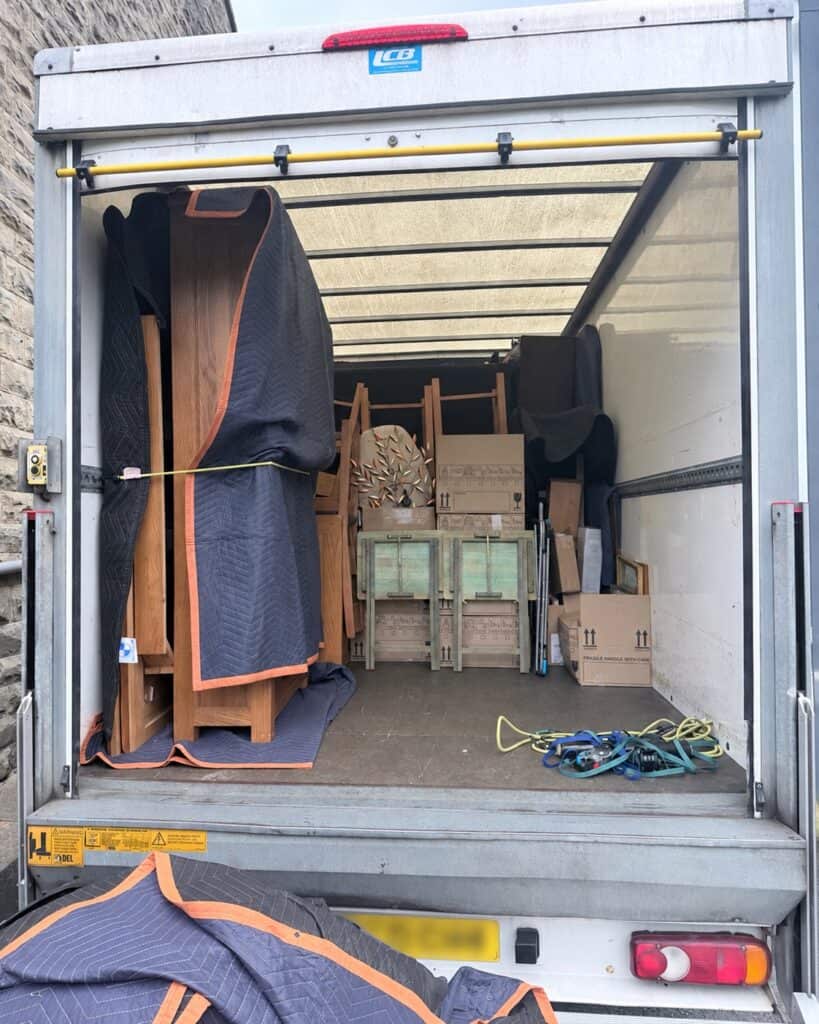 Furniture protected with removal blankets and secured inside a JCT 20 Removals Luton van.